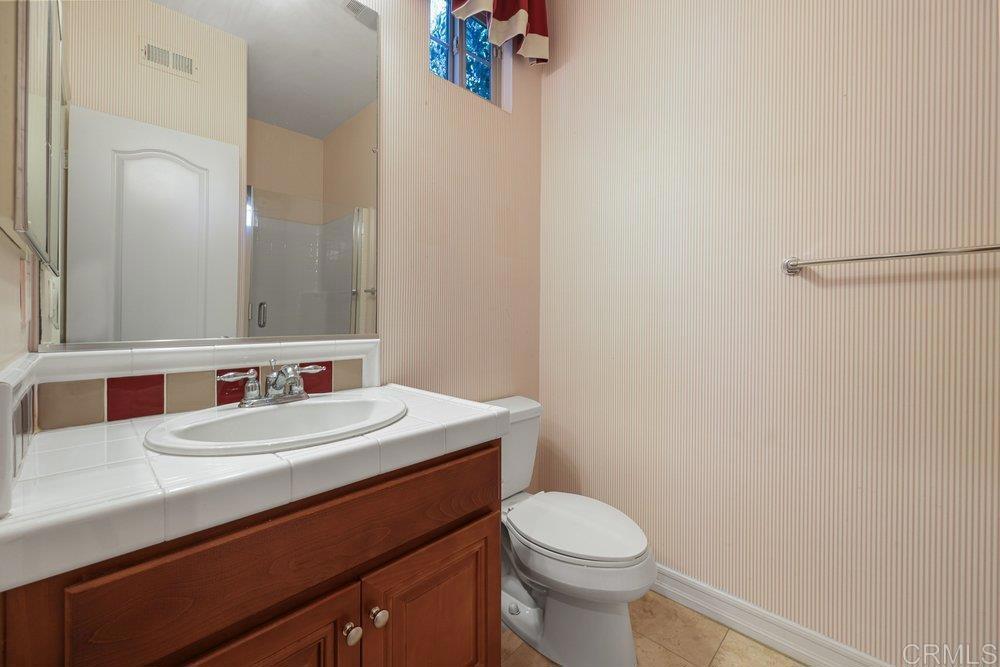 2204 Huntington Point Road, Unit 13 Chula Vista, CA 91914 - Photo 22 of 28 a bathroom with a sink a toilet and mirror