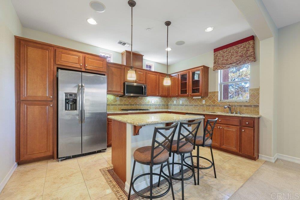 2204 Huntington Point Road, Unit 13 Chula Vista, CA 91914 - Photo 23 of 28 a kitchen with stainless steel appliances granite countertop a refrigerator a sink and a stove