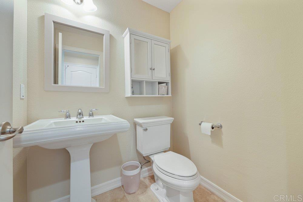 2204 Huntington Point Road, Unit 13 Chula Vista, CA 91914 - Photo 26 of 28 a bathroom with a toilet sink and mirror