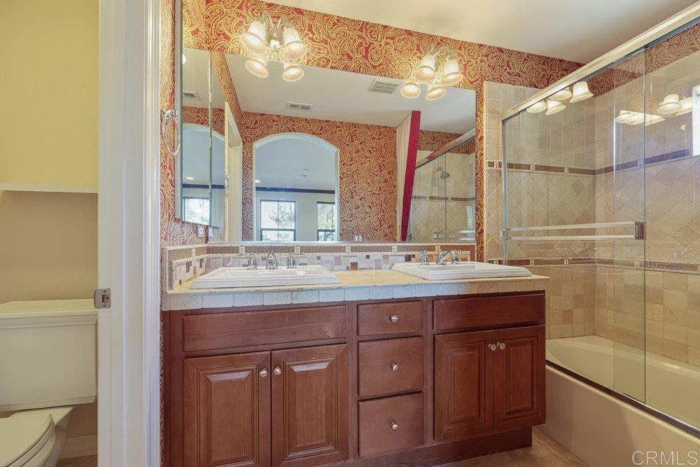 2204 Huntington Point Road, Unit 13 Chula Vista, CA 91914 - Photo 7 of 28 a bathroom with a granite countertop sink a mirror and a shower