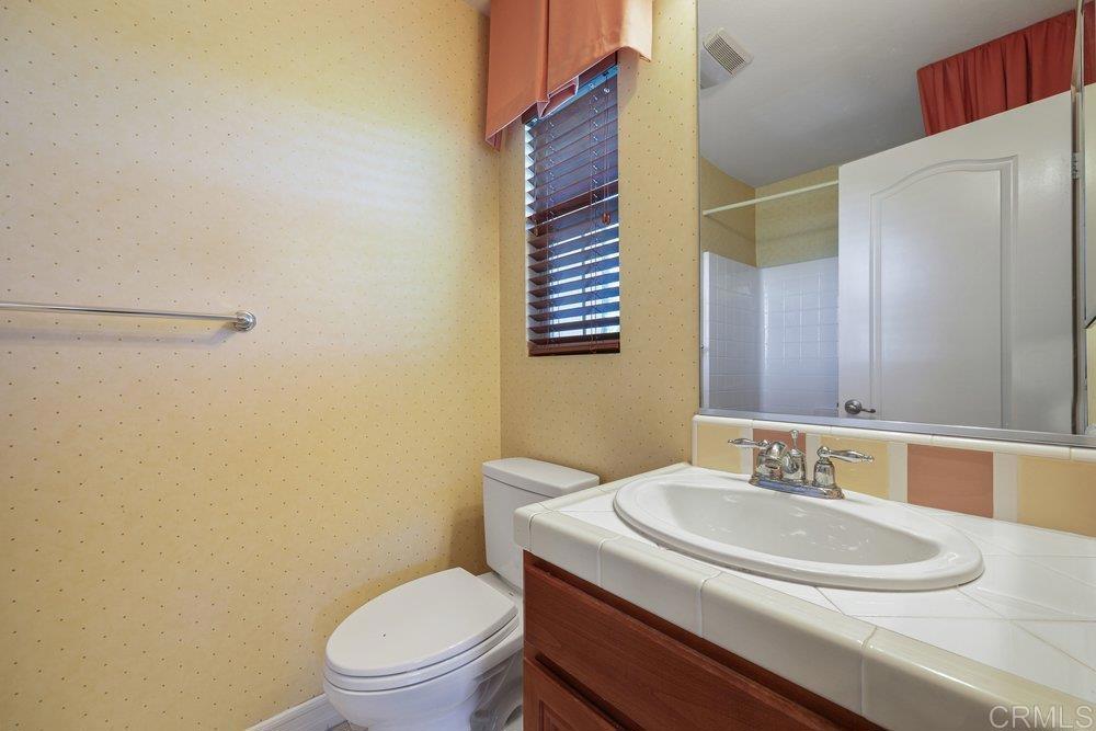 2204 Huntington Point Road, Unit 13 Chula Vista, CA 91914 - Photo 10 of 28 a bathroom with a sink a toilet and a mirror