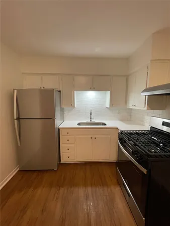 a kitchen with a refrigerator and a stove