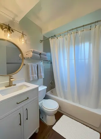 a bathroom with a sink a toilet and shower curtain