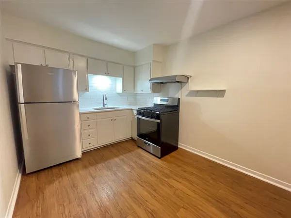a kitchen with stainless steel appliances a refrigerator sink and cabinets