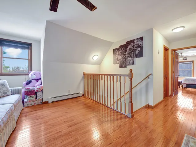 a view of a livingroom with furniture and hardwood floor