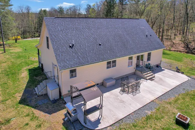 an aerial view of a house with a yard