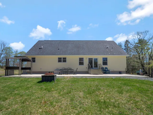 a front view of house with yard and outdoor seating