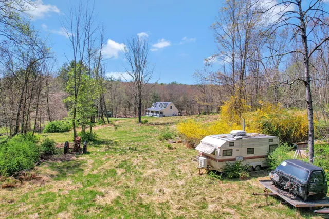 a backyard of a house with table and chairs