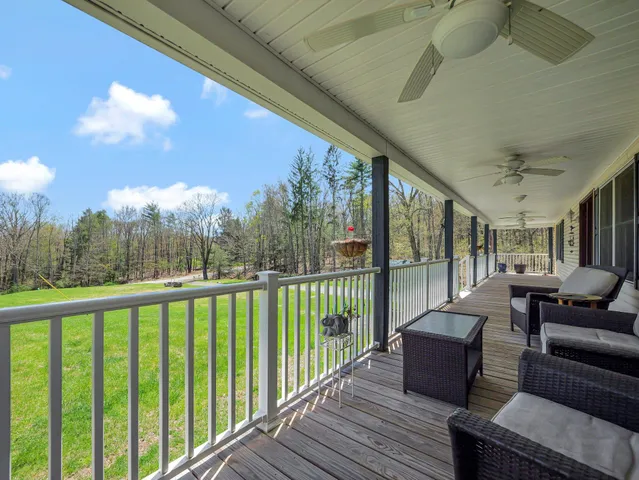a view of a balcony with couches and wooden floor