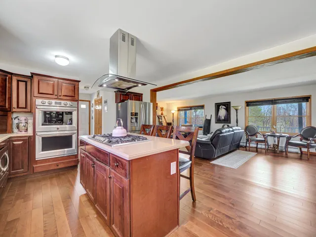 a open kitchen with stainless steel appliances granite countertop a stove and a refrigerator