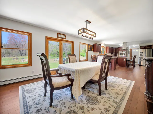 a view of a a dining room with furniture window and wooden floor