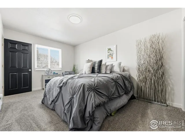 a bedroom with a bed and with furniture