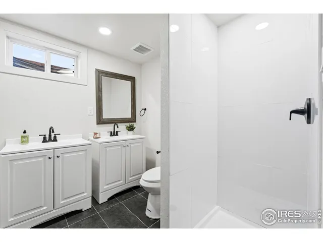 a bathroom with sink mirror and toilet