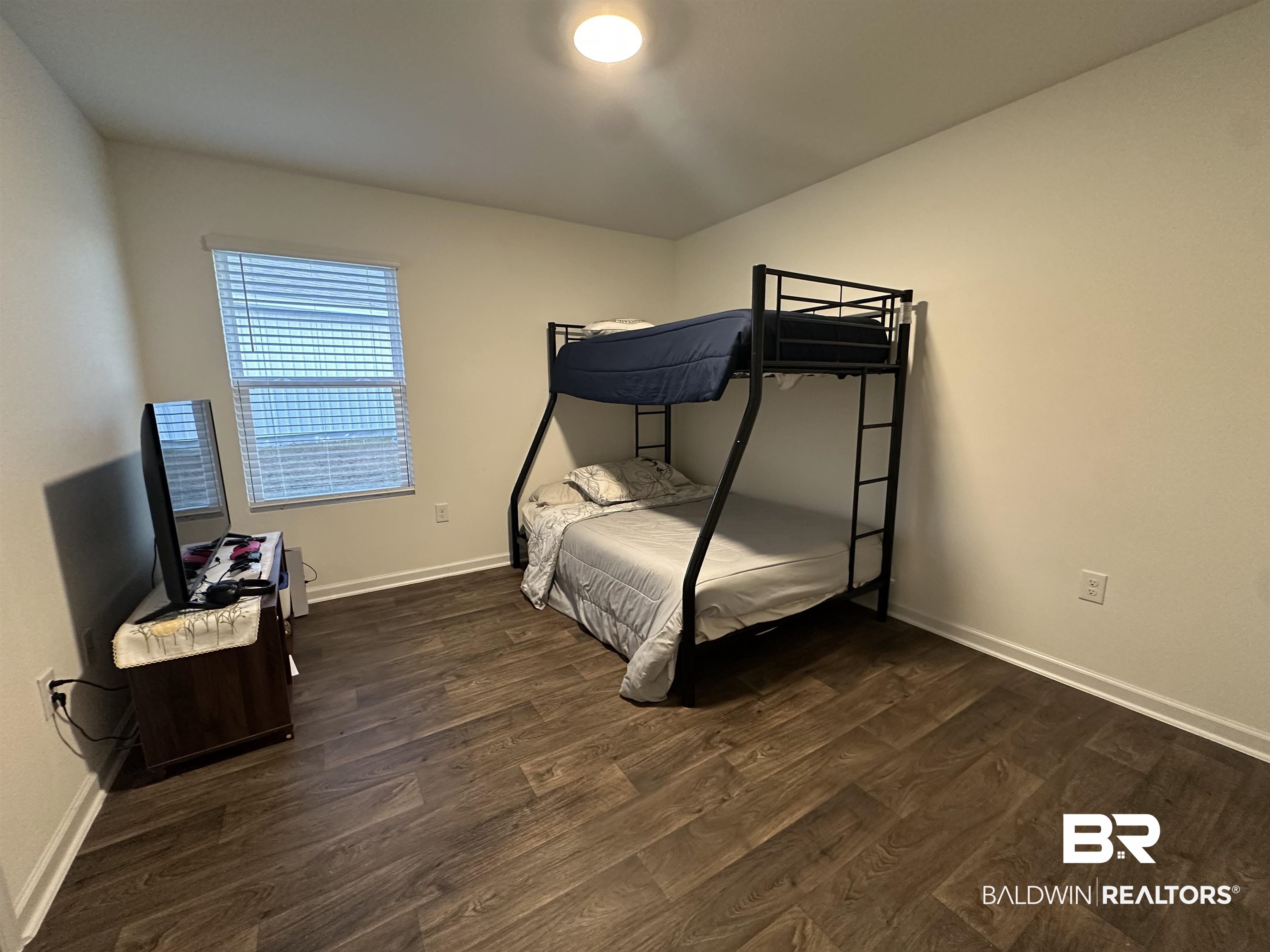 23792 Unbridled Loop Daphne, AL 36526 - Photo 26 of 36 Bedroom with dark wood-type flooring and baseboards