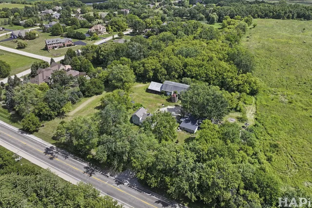 an aerial view of a house with a yard