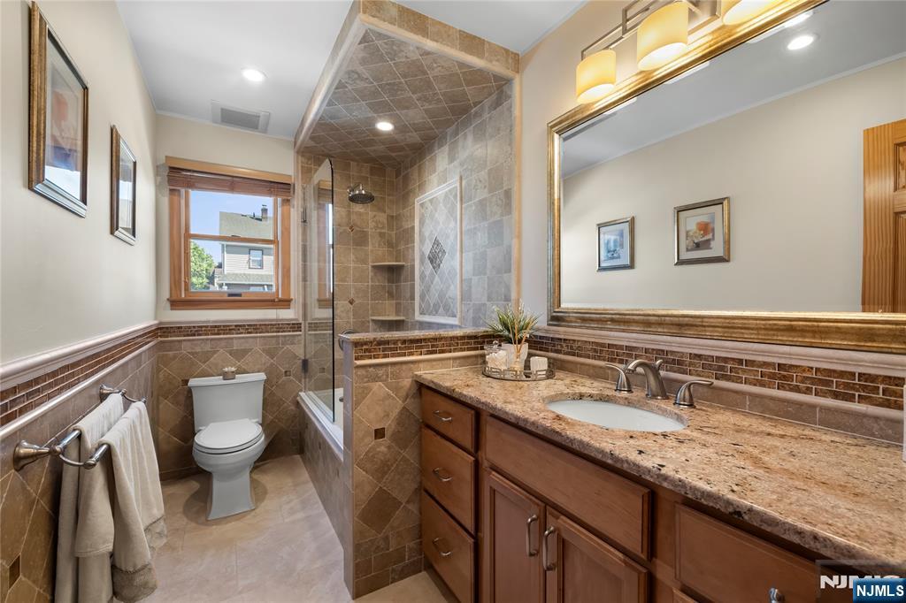 66 Roehrs Drive Wallington, NJ 07057 - Photo 25 of 37 a bathroom with a granite countertop sink mirror and toilet