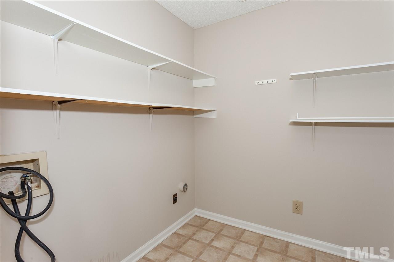 8027 Brown Bark Place Raleigh, NC 27615 - Photo 14 of 19 a view of a room with racks on the wall