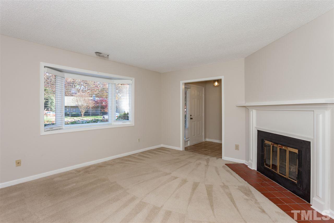 8027 Brown Bark Place Raleigh, NC 27615 - Photo 4 of 19 a view of empty room with window and fireplace