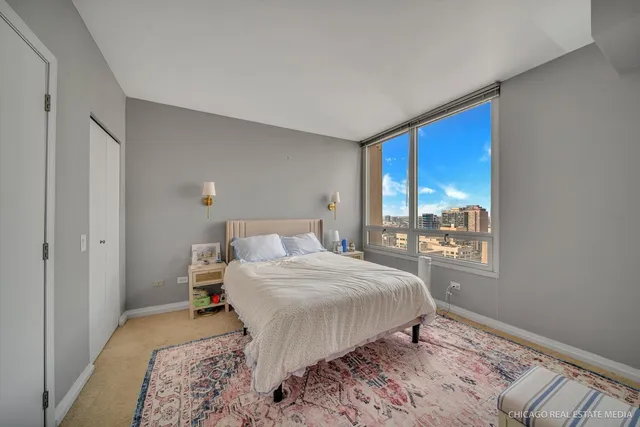 a bedroom with a large bed and a window