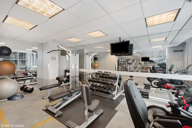 a room with gym equipment and a flat screen tv
