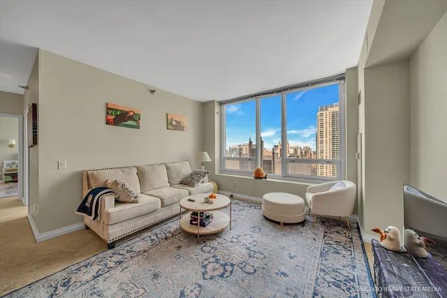 a living room with furniture and a large window