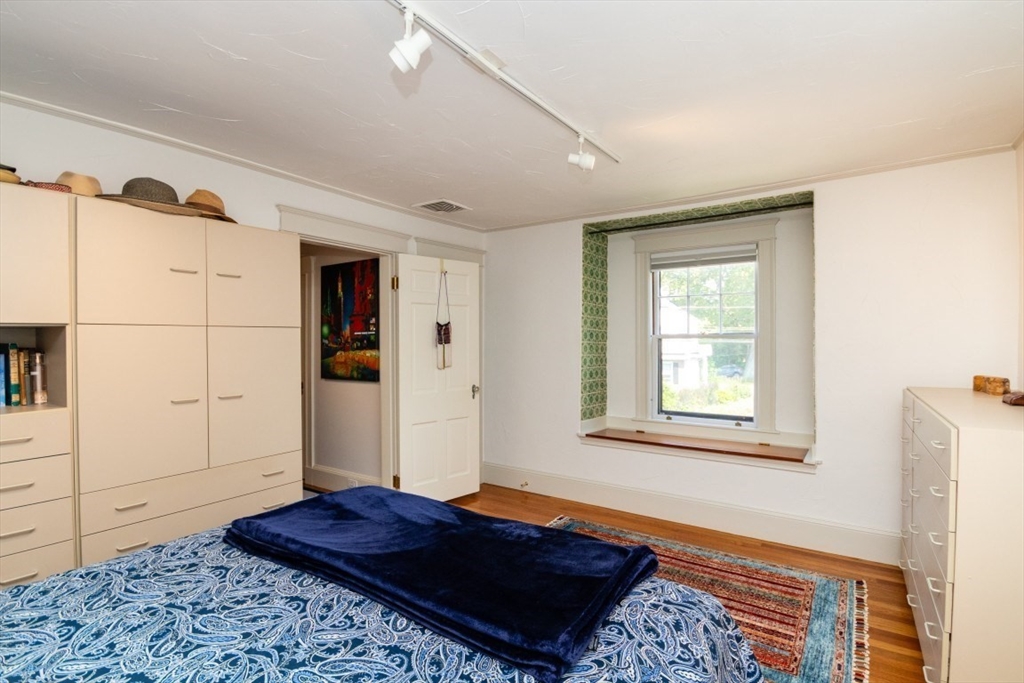 4 Charlotte Road Newton, MA 02459 - Photo 24 of 32 a bedroom with a bed and wooden floor