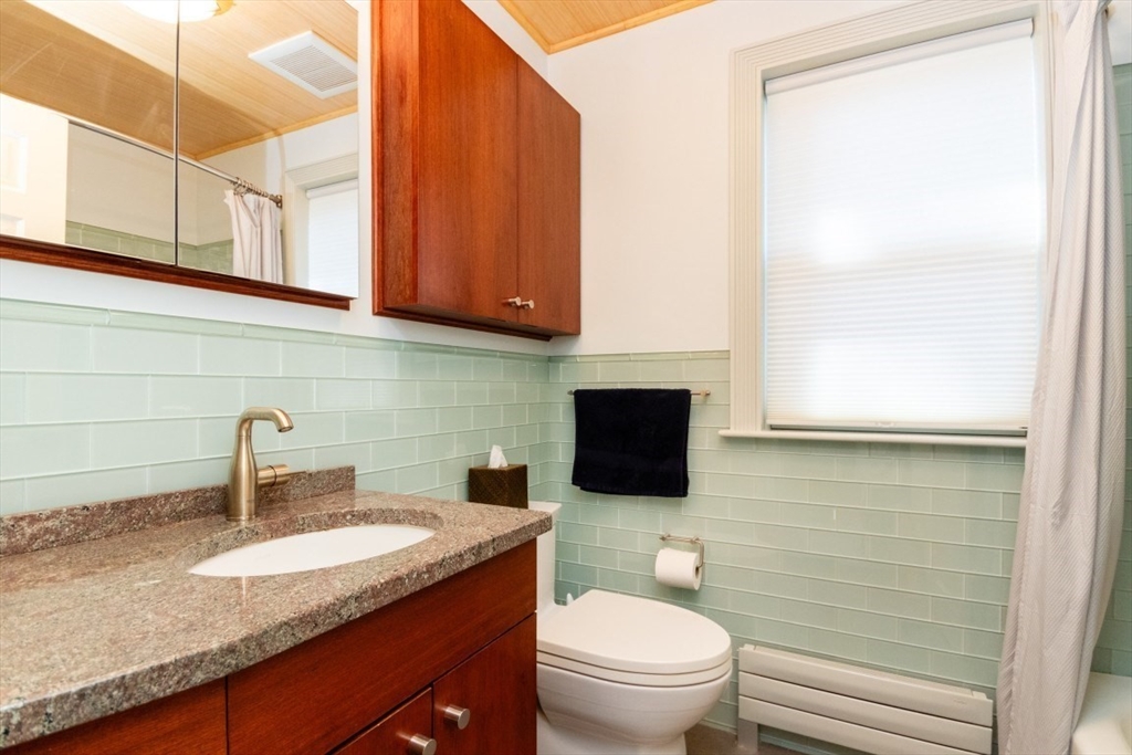 4 Charlotte Road Newton, MA 02459 - Photo 25 of 32 a bathroom with a granite countertop toilet sink and mirror