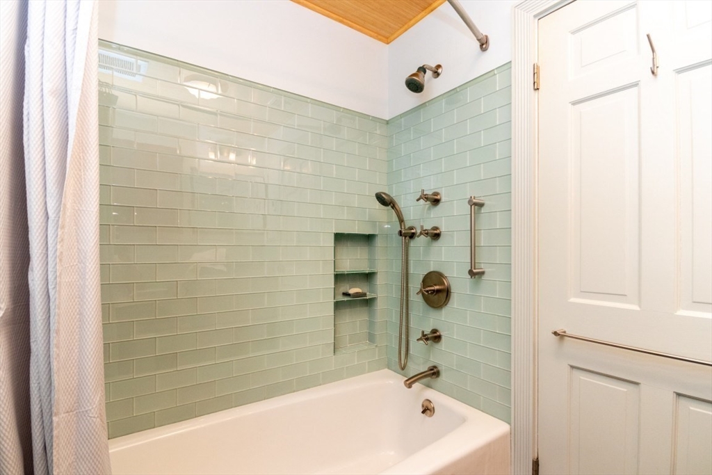 4 Charlotte Road Newton, MA 02459 - Photo 26 of 32 a bathroom with a bathtub and shower