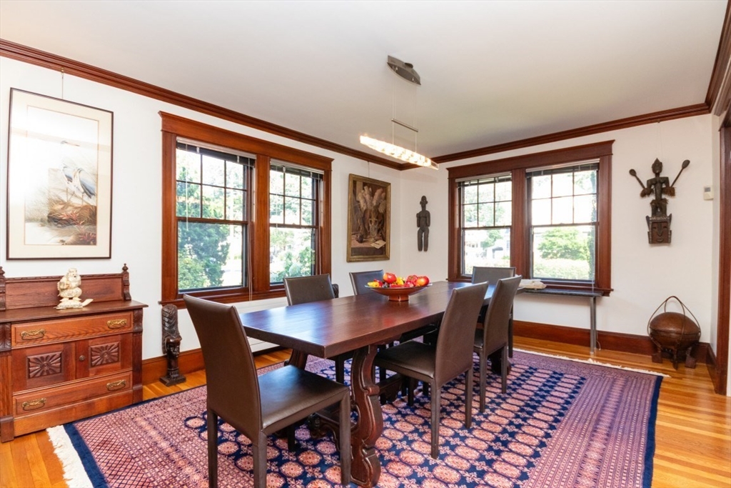 4 Charlotte Road Newton, MA 02459 - Photo 6 of 32 a dining room with wooden floor a chandelier a wooden table and chairs