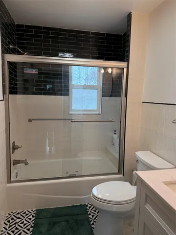 a bathroom with a toilet a sink and a bathtub