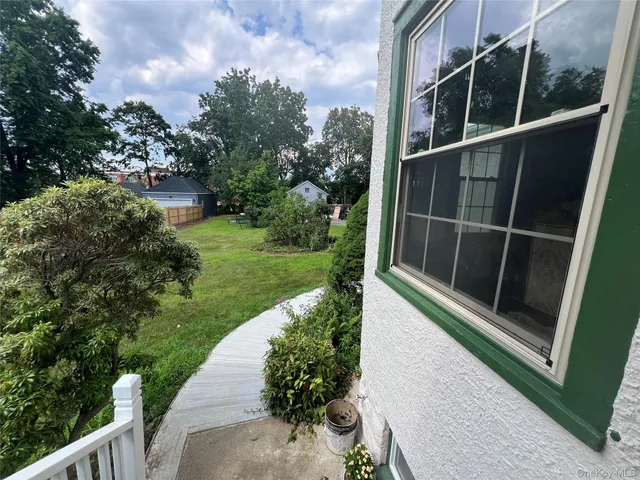 a view of a balcony with yard