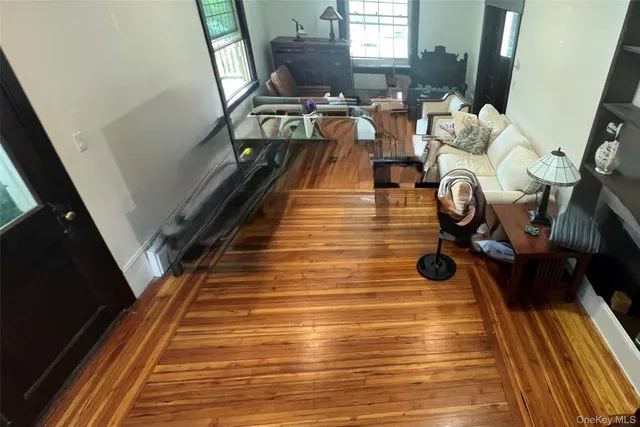 a view of entryway and hall with wooden floor