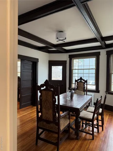 a dining room with furniture and wooden floor