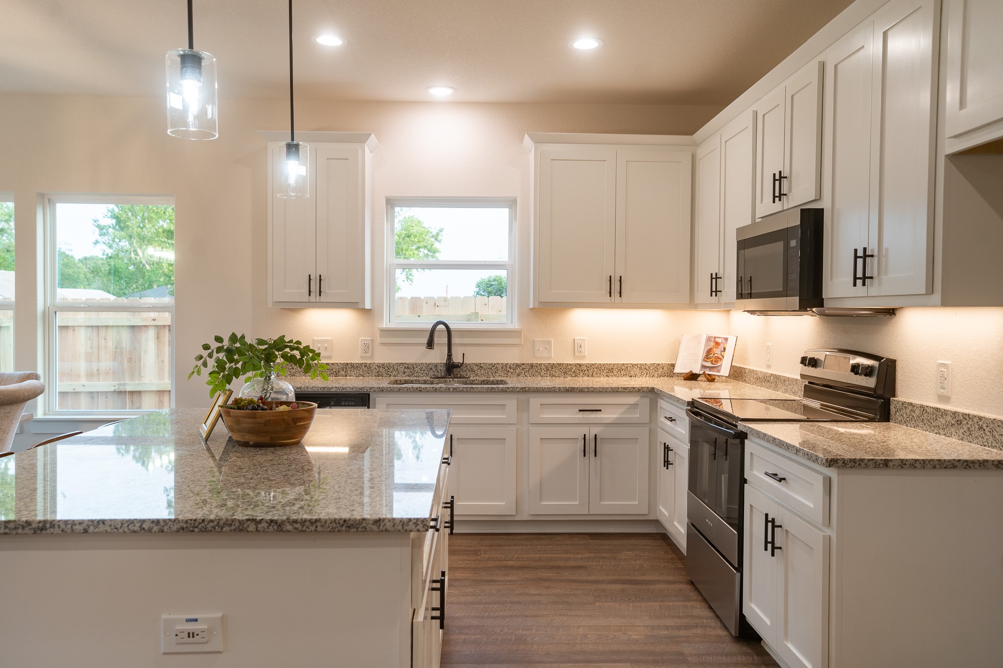 304 String Prairie Way Smithville, TX 78957 - Photo 11 of 30 Kitchen featuring electric stove, a sink, healthy amount of natural light, white cabinets, and recessed lighting