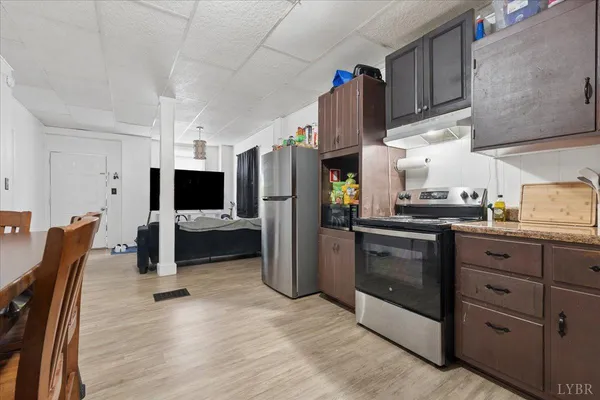 a living room with furniture a flat screen tv and a window
