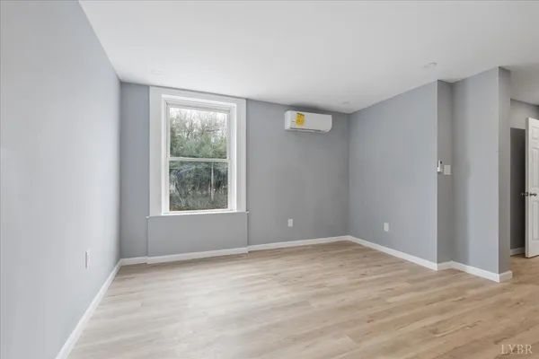 a view of a house with a yard and wooden fence