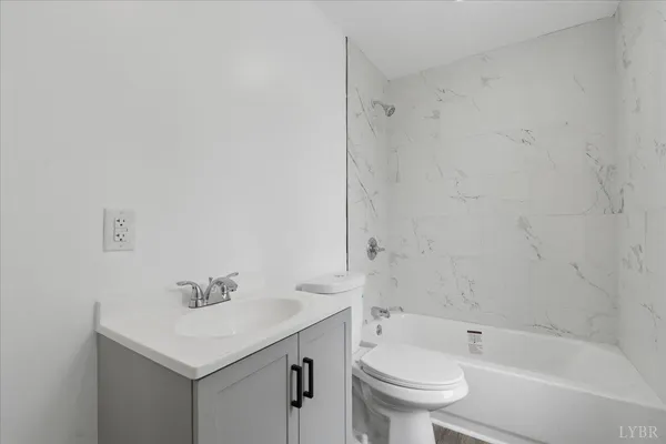 a bedroom with furniture and large windows