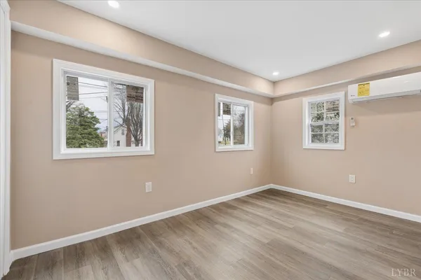 a room with furniture a flat screen tv and a window