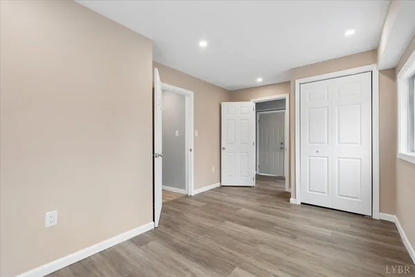 a living room with furniture a flat screen tv and a window