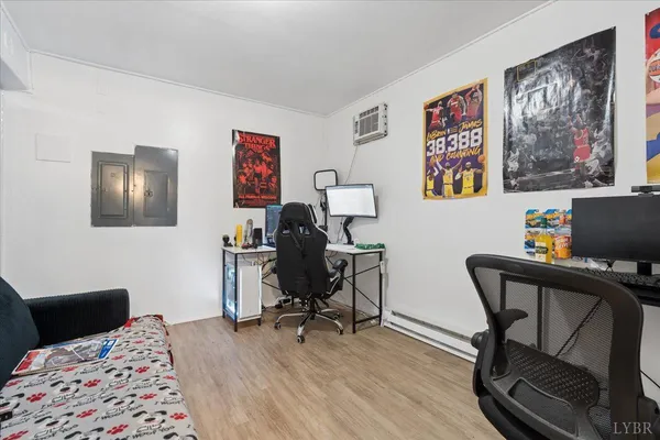 a bed room with a bed window and a computer on a table