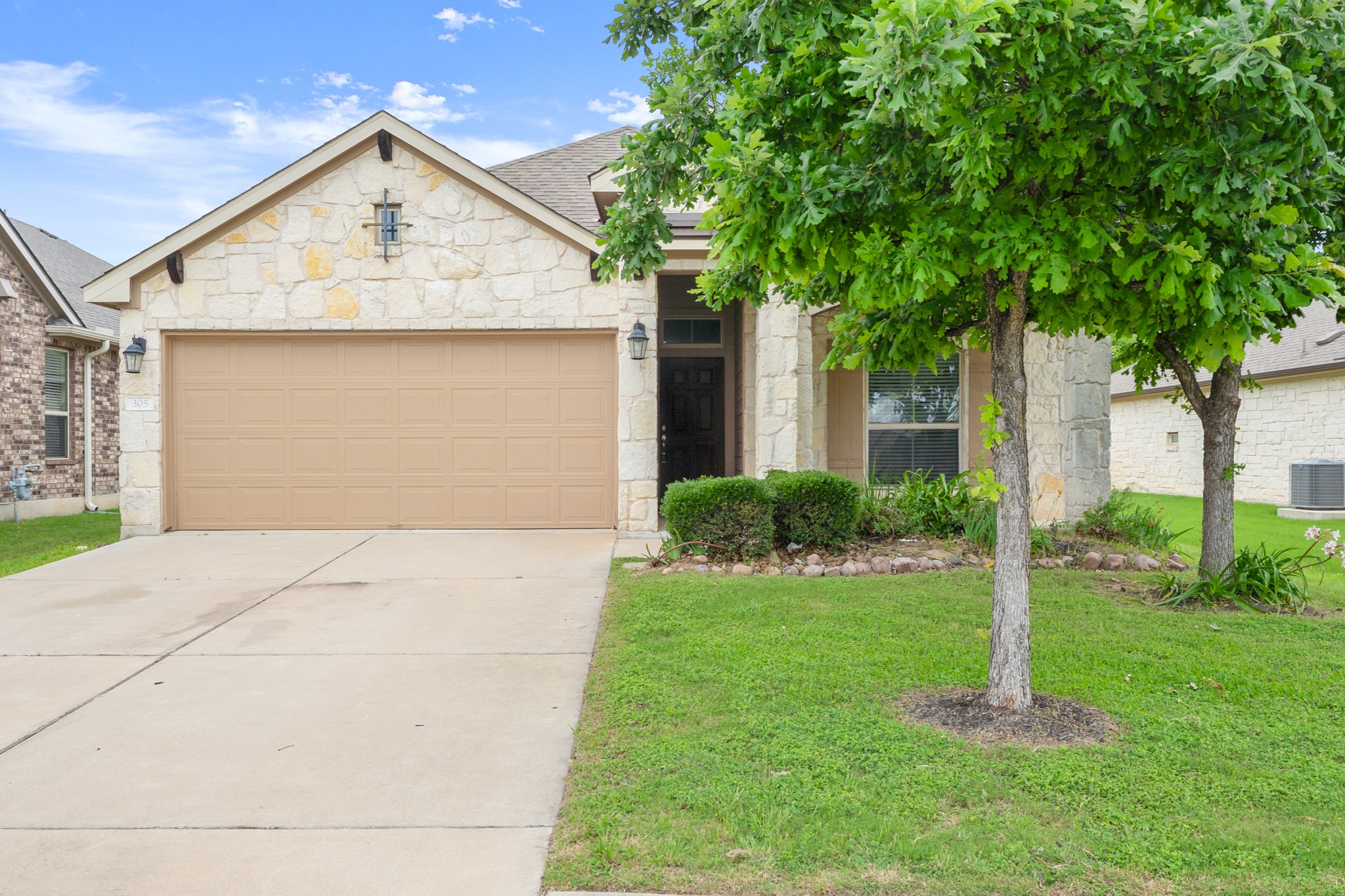 305 Longhorn Cavern Road Leander, TX 78641 - Photo 20 of 21 Welcome home! This charming stone-front beauty offers great curb appeal and a spacious two-car garage.