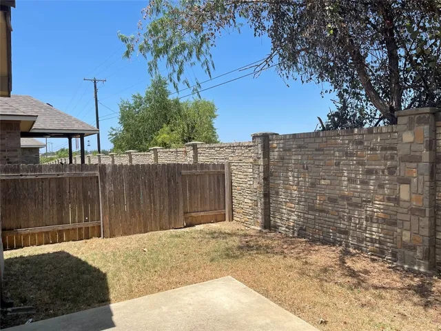 a view of a brick house with a yard