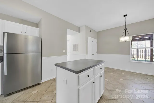 a kitchen with stainless steel appliances granite countertop a refrigerator a sink and a refrigerator