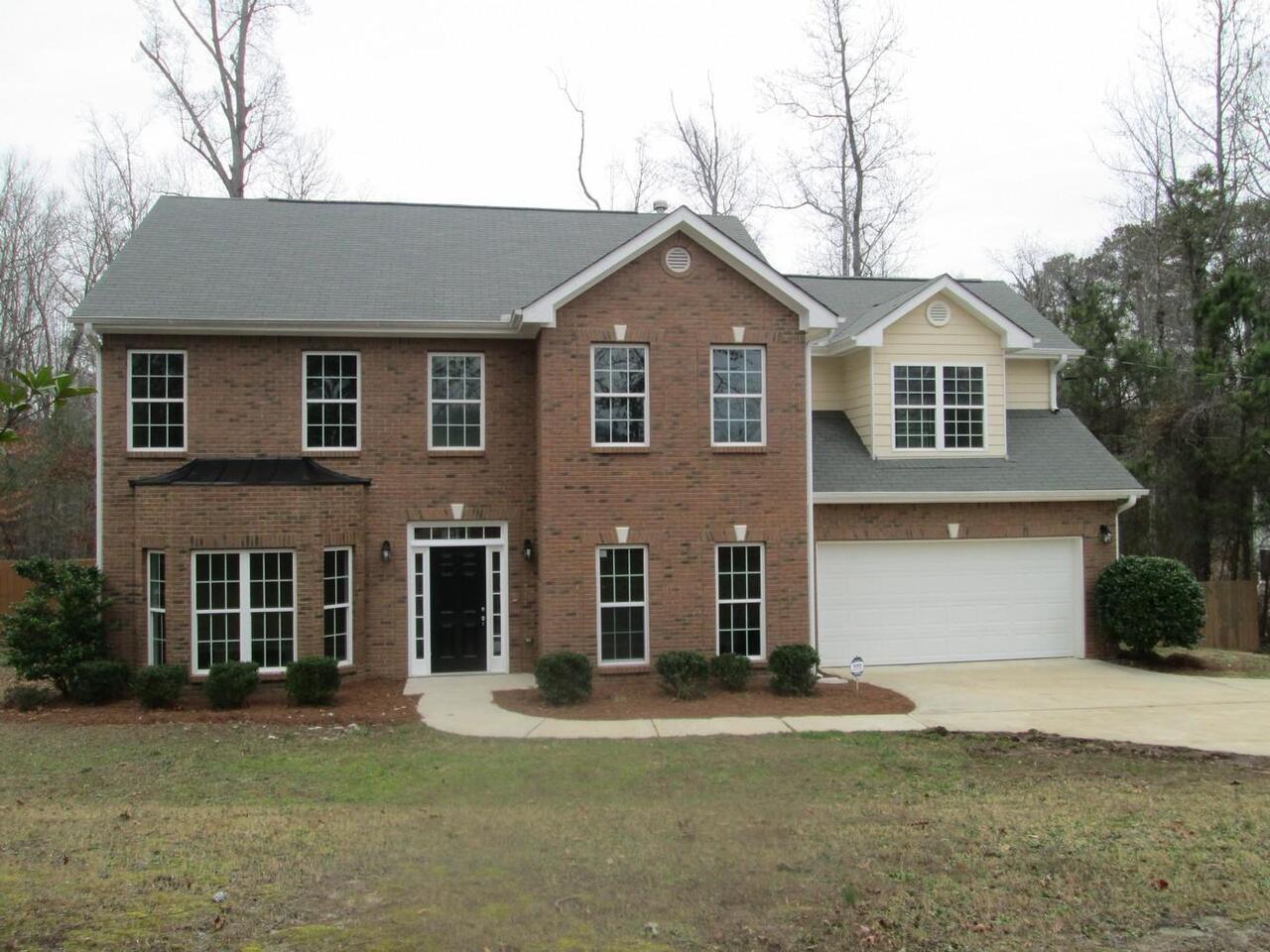 2795 Fairburn Road Southwest Atlanta, GA 30331 - Photo 1 of 1 a front view of a house with a yard