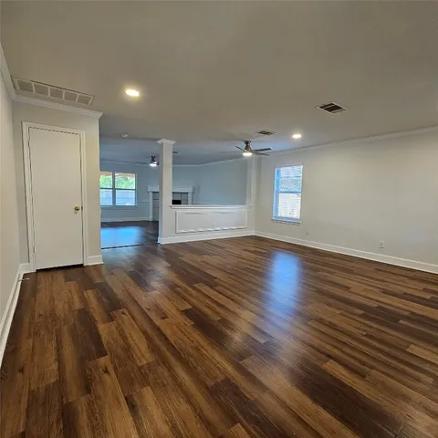 wooden floor in an empty room with a window