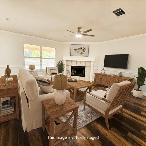 a living room with furniture a flat screen tv and a fireplace