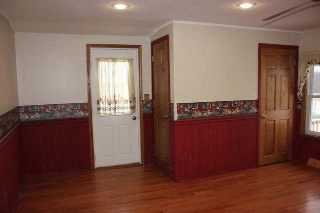 11830 Nelson Road Morrison, IL 61270 - Photo 2 of 15 an empty room with wooden floor and windows