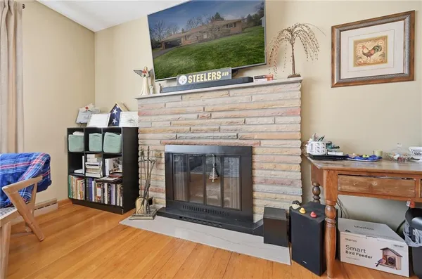 a living room with fireplace furniture and a flat screen tv