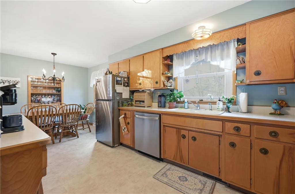 256 Donald Road Hermitage, PA 16148 - Photo 15 of 28 a kitchen with stainless steel appliances granite countertop a stove a sink and a refrigerator