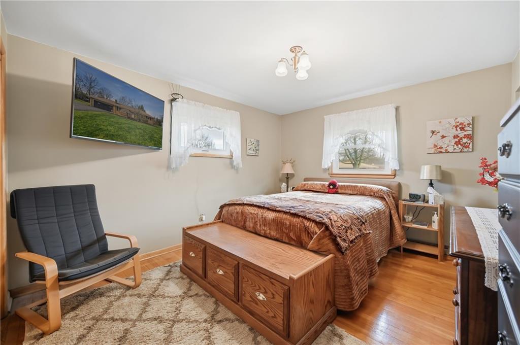 256 Donald Road Hermitage, PA 16148 - Photo 17 of 28 a bedroom with a bed and wooden floor